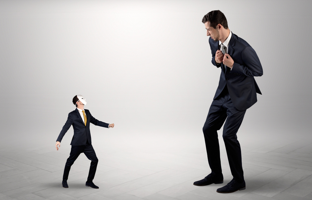 Conflict between small masked businessman and big elegant businessman